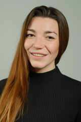 Fototapeta premium Portrait of a young pretty girl with long red hair