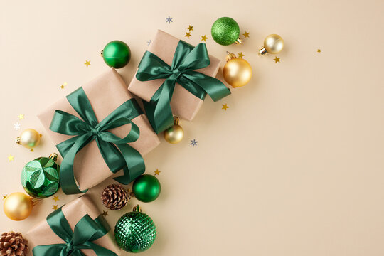 Set the tone for the New Year with considerate gift choices. Top view flat lay of present boxes, yule tree ornaments, cones, stars on beige background with ad placement