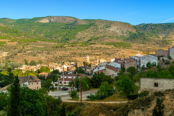 Fototapeta na wymiar View of the village of Casas Altas in Rincón de Ademuz in Spain, on a sunny afternoon. Summer 2023