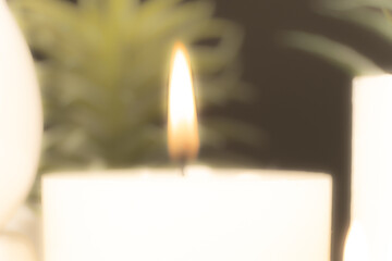 Blurred background of burning candle, fire from candle