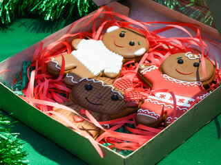 Gingerbread man and woman in a box with red ribbons