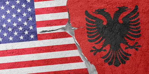 USA and Albania flags on a stone wall with a crack, illustration of the concept of a global crisis...