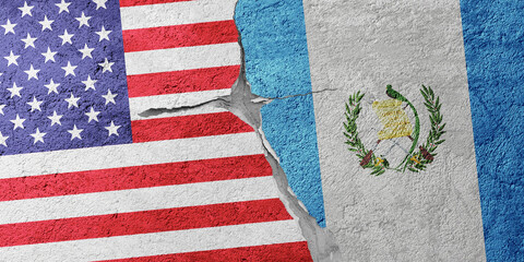 USA and Guatemala flags on a stone wall with a crack, illustration of the concept of a global crisis in political and economic relations