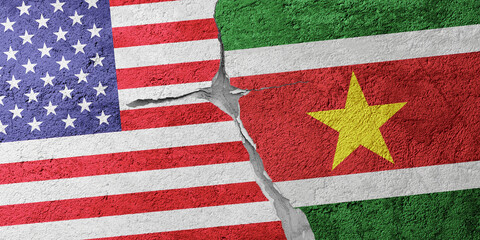 USA and Suriname flags on a stone wall with a crack, illustration of the concept of a global crisis...