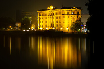 Fototapeta premium Illuminated Building with Reflection on Water. Building at night. High quality photo