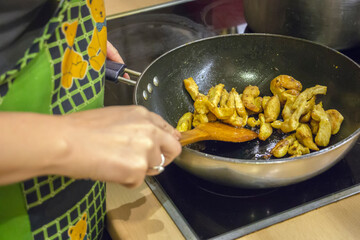 Beautiful young housewife in the kitchen
