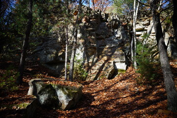 Tall rock stone formations sit in a forest for rock climbing.