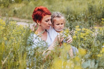 Grandmother or a mother and her granddaughter or daughter are bonding together on a summer day...