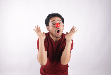 Photograph of person with red nose making gestures of approval. Concept of clowns.