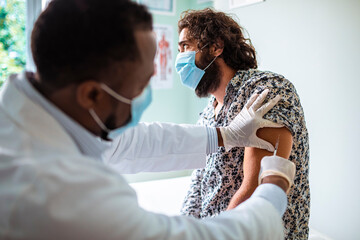 Man Receiving Vaccine from Medical Professional at the hospital