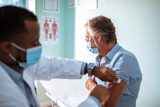 Man Receiving Vaccine from Medical Professional at the hospital
