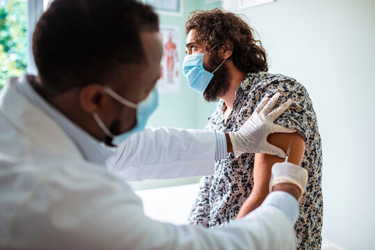 Man Receiving Vaccine from Medical Professional at the hospital