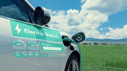 Electric car plug in with charging station, recharge battery by EV charger cable display smart digital battery status hologram with nature background. Futuristic green energy infrastructure.Peruse
