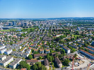 Obraz premium Aerial view of City of Zürich North with urban roads and residential buildings on a sunny late spring day. Photo taken June 14th, 2023, Zurich, Switzerland.