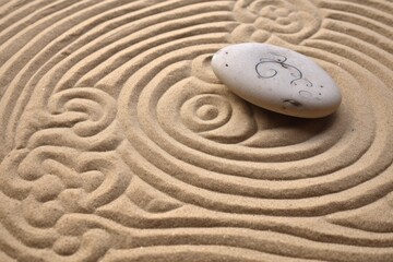 Zen sand garden meditation stone background. Balanced Stones and lines drawing in sand for relaxation. Concept of harmony, balance and meditation, spa, massage, relax.
