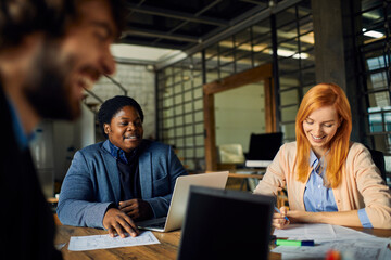 Young entrepreneurs collaborating on new project in modern office