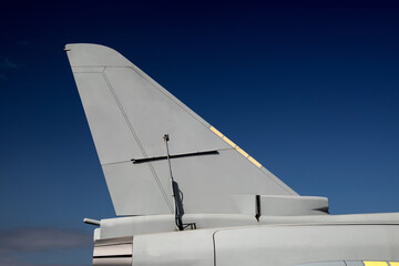 Jet Fighter Aircraft Tail Section Against a Clear Blue Sky - 679787292