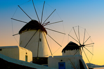 Mykonos windmills at sunset on a perfect cloudless day on the greek islands.  