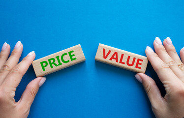 Price and Value symbol. Concept word Price and Value on wooden blocks. Businessman hand. Beautiful...