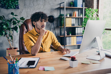 Photo of successful minded man sitting work table browsing database software connection server...