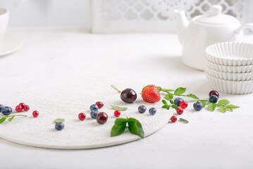Fresh strawberries, blueberries and cranberries on a white background