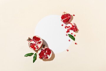 Top view cosmetic background for product presentation with pomegranate extract. Empty Cosmetic circle podium and pomegranate extract on light beige and white background. Flat lay