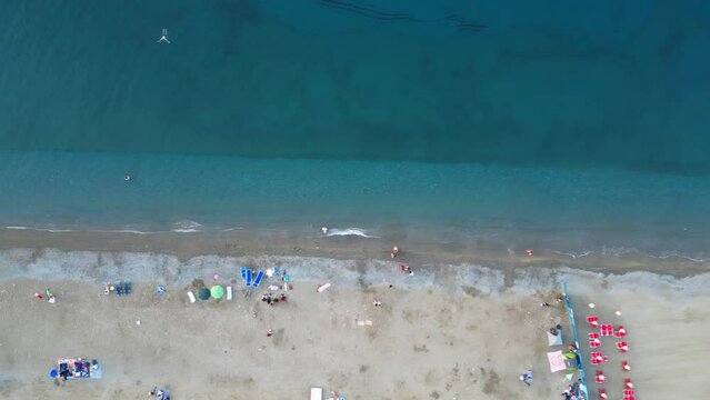 Beach with vacationers, view from a copter.