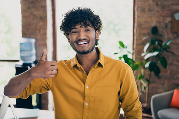 Photo of professional nice man recruiter boss showing thumb up good day nice result workspace indoors