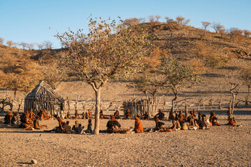 Himba women gather in a small village near Opuwo, Kunene Region, Namibia to sell their traditional...