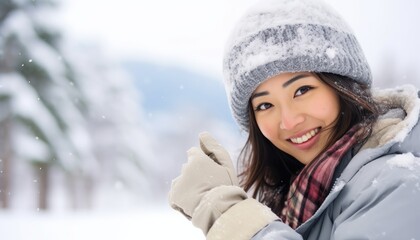 Fototapeta na wymiar young beautiful asian girl in winter clothes in a snowy setting