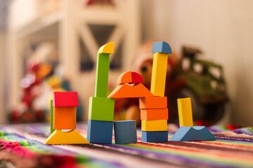 Children's toys on a colorful rug in the room 