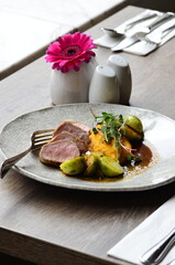 roasted pork loin with brussels sprouts and sauce, serving food