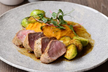 roasted pork loin with brussels sprouts and sauce, serving food