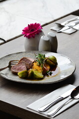 roasted pork loin with brussels sprouts and sauce, serving food