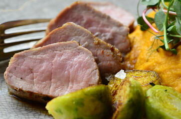 roasted pork loin with brussels sprouts and sauce, serving food