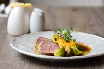 roasted pork loin with brussels sprouts and sauce, serving food