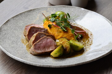 roasted pork loin with brussels sprouts and sauce, serving food