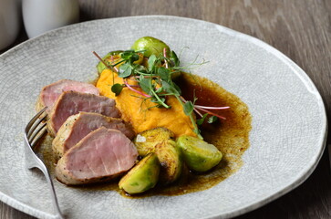 roasted pork loin with brussels sprouts and sauce, serving food