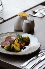 roasted pork loin with brussels sprouts and sauce, serving food