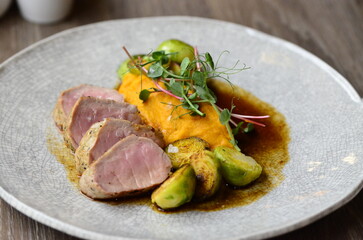 roasted pork loin with brussels sprouts and sauce, serving food