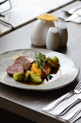 roasted pork loin with brussels sprouts and sauce, serving food