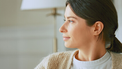 Relaxed woman drinking coffee or herbal tea and feeling carefree and refreshed while relaxing on...