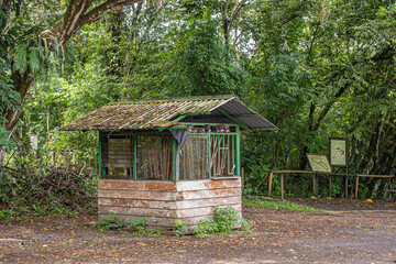 Fototapeta na wymiar Costa Rica, Parque Nacional Carara - July 22, 2023: Old and non-maintained Garden tool shed set against green foliage