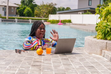 Beautiful African girl Using a laptop computer Video chat with friends over the internet While...