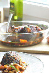 Lamb knee with beans, background of traditional seasonal food, roast meat