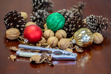 Cracking Christmas nuts using a traditional metal nutcracker. Traditional Christmas background