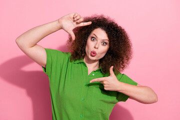 Photo of funky flirty young lady wear green shirt showing arms photo gesture sending kiss isolated pink color background