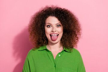 Photo of carefree funky young lady wear green shirt showing stick out isolated pink color background