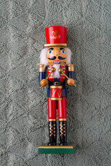 Traditional wooden toy for Christmas, Nutcracker on a soft blanket..