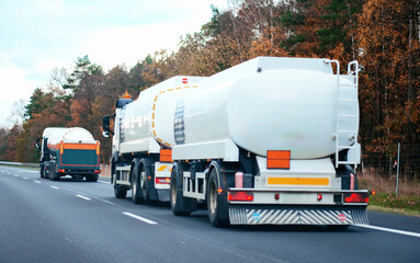 Petrol cargo truck driving on highway hauling oil products. Fuel delivery transportation and...